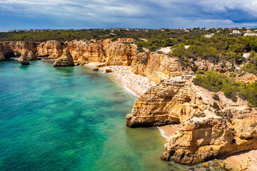 Praia da Marinha, beautiful beach Marinha in Algarve, Portugal. Navy Beach (Praia da Marinha) with flying seagulls over the beach, located on the Atlantic coast in Lagoa Municipality, Algarve.