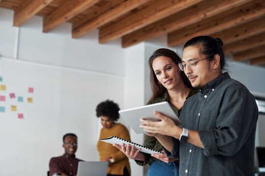 Teamwork, paperwork and tablet of business people in office, planning and research for startup in creative agency. Feedback, staff or web developer with digital for layout design, solution and smile