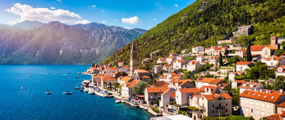 View of the historic town of Perast at famous Bay of Kotor on a beautiful sunny day with blue sky and clouds in summer, Montenegro. Historic city of Perast at Bay of Kotor in summer, Montenegro. © daliu