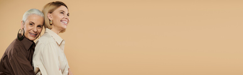 A smiling mother embraces her daughter in a cozy atmosphere.