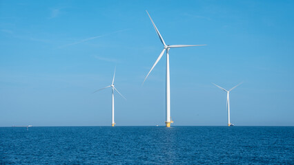Breathtaking Windmill Park Soaring Above Tranquil Waters in the Netherlands Under Clear Blue Skies