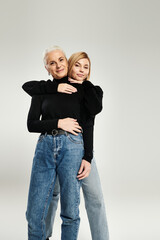A loving embrace shared between a mother and her adult daughter.