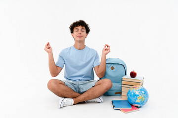 Calm peaceful boy guy high school male pupil student teenager sitting near books copybooks backpack...