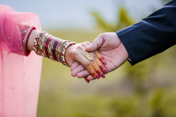 Young married couple holding hands, ceremony wedding day	