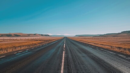 Naklejka premium Open road stretching towards the horizon with no vehicles.