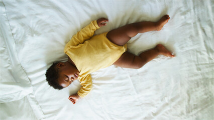 Infant Sleeping Peacefully on Soft Bed Sheets in a Cozy Bedroom