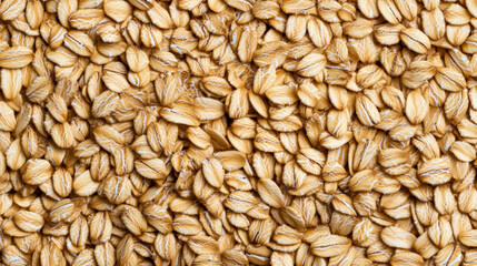 Fototapeta premium Macro shot of the texture of rolled oats highlighting the flattened light brown grains with intricate layers 
