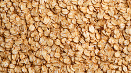Fototapeta premium Macro shot of the texture of rolled oats highlighting the flattened light brown grains with intricate layers 