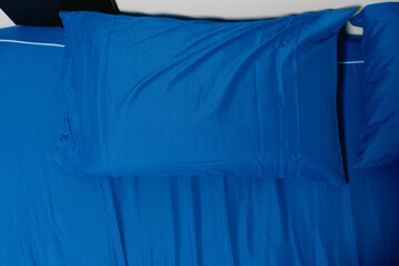 Pillow blue and blue bed sheet a classic bedroom in home. Top view