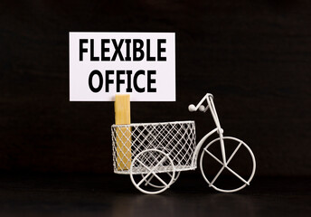 Flexible office symbol. Concept words Flexible office on beautiful white paper on wooden...