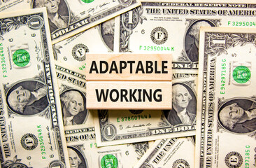 Adaptable working symbol. Concept words Adaptable working on beautiful wooden block. Beautiful dollar bills background. Dollar bills. Business Adaptable working concept. Copy space.