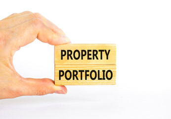 Property portfolio symbol. Concept words Property portfolio on beautiful wooden block. Beautiful white paper background. Businessman hand. Business Property portfolio concept. Copy space.