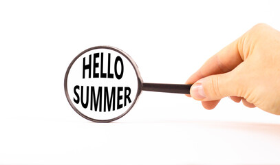 Hello summer symbol. Concept words Hello summer in beautiful magnifying glass. Beautiful white paper background. Businessman hand. Business lifestyle Hello summer concept. Copy space.