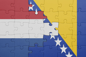 puzzle with the colourful national flag of bosnia and herzegovina and flag of netherlands.