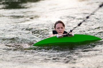 Obraz premium A girl is using her wakeboard in the water.