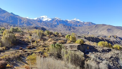 The Annapurna Circuit Trekking path through steep snowcapped mountains in Himalaya, Nepal