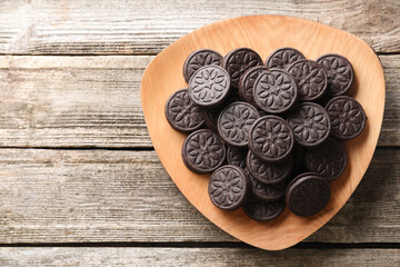 Many tasty sandwich cookies on wooden table, top view. Space for text
