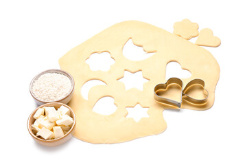 Raw dough, flour, butter and cookie cutters isolated on white