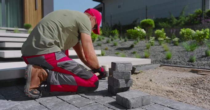 Laying Stone Pavers in a Modern Outdoor Garden in Bright Afternoon Sunlight