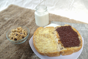 Bread with chocolate choco rice and butter with milk and snack for breakfast	
