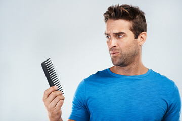 Man, comb and worry for hair loss in studio with crisis, genetic disease and thyroid problem. Male...