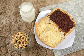 Bread with chocolate choco rice and butter with milk and snack for breakfast	
