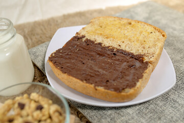 Bread with chocolate spread filling, milk and snack for breakfast	
