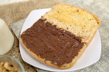 Bread with chocolate spread filling, milk and snack for breakfast	
