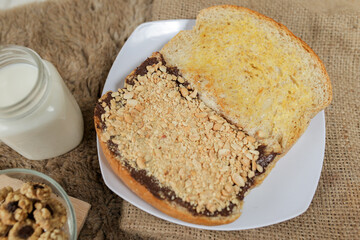 Bread with peanut, chocolate and butter spread on a table for breakfast	
