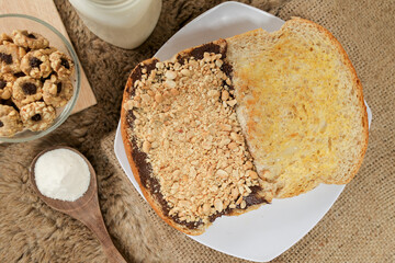Bread with peanut, chocolate and butter spread on a table for breakfast	
