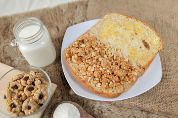 Bread with peanut and butter spread on a table for breakfast	
