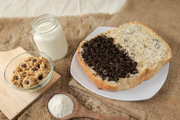 Bread with chocolate cookies oreo cheese and butter spread on a plate for breakfast	
