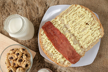Bread with smoked beef on a plate for breakfast and coffee break	
