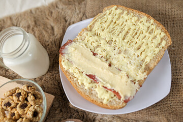 Bread with smoked beef and mozarella cheese on a plate for fast food breakfast or coffee break.	
