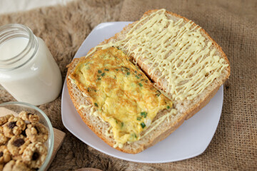 Bread with scrambled egg sandwich on a plate for breakfast and coffee break	
