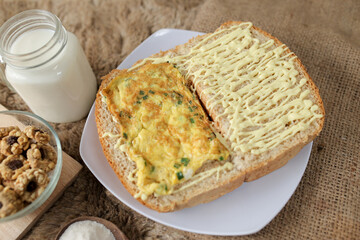 Bread with scrambled egg sandwich on a plate for breakfast and coffee break	
