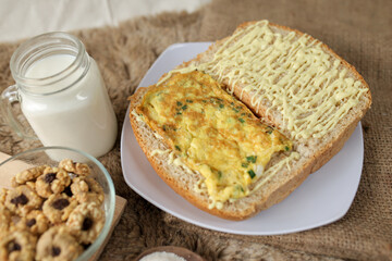Bread with scrambled egg sandwich on a plate for breakfast and coffee break	
