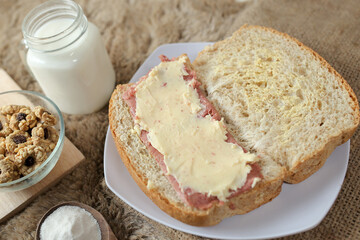Bread with smoked beef and mozarella cheese on a plate for fast food breakfast or coffee break.	
