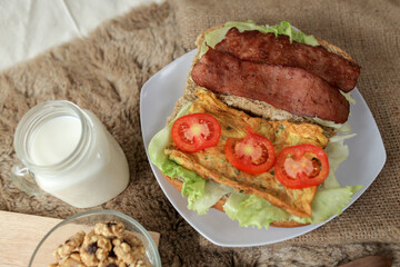 Big breakfast, bread, chicken slice, tomato, lettuce, smoked beef, egg, salad with milk. Bread sandwich fresh and healthy food meal lunch dinner breakfast slices of sandwiches.
