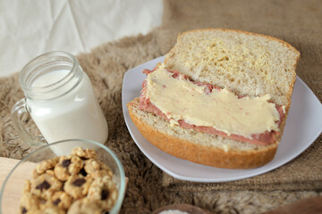 Bread with smoked beef and mozarella cheese on a plate for fast food breakfast or coffee break.	
