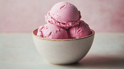 Rich and creamy raspberry ice cream scooped into a bowl, highlighted against a simple background.