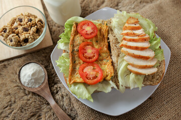 Big breakfast, bread, chicken slice, tomato, lettuce, smoked beef, egg, salad with milk. Bread sandwich fresh and healthy food meal lunch dinner breakfast slices of sandwiches.