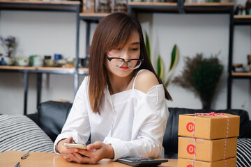 Successful entrepreneur business woman with online sales and Parcel shipping in her home office.