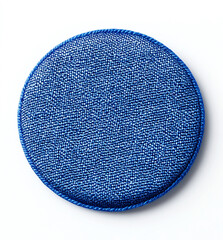 A blue circular sticker with rounded edges, made of fabric material, is on the white background