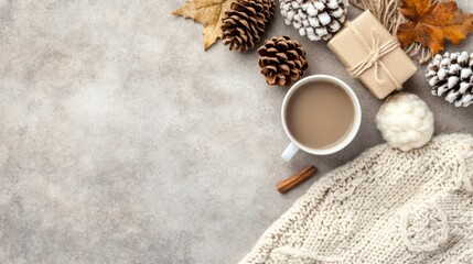 A warm cup of coffee sits beside a wrapped gift and an open book on a textured fabric surface, creating a serene atmosphere for relaxation and enjoyment