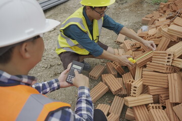 Professional architect engineer with hard hat and blueprint at building construction site house building permit background. Architects looking at blueprints. Construction and engineering industry