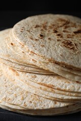 Many tasty homemade tortillas on table, closeup