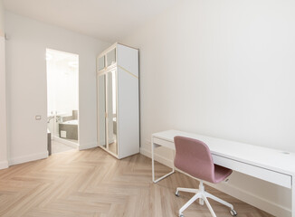 Minimalism Children, Young Adult Living Room Interior. Desk, Table Wardrobe Closet in Background. Open Door to Bathroom. White Walls and Ceiling. LED Light