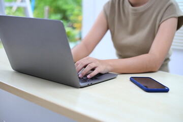 Successful Asian businesswoman sitting at desk working using laptop computer in office. Business and people concept. Businesswoman using laptop computer and working with documents.