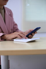 Successful Asian businesswoman sitting at desk working using laptop computer in office. Business and people concept. Businesswoman using laptop computer and working with documents.